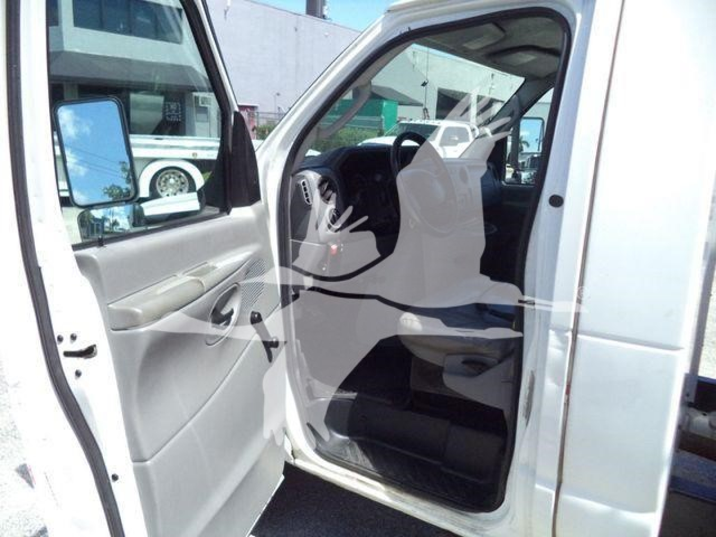 Ford Econoline E-Series cab interior showing front door and driver seat with steering wheel visible.