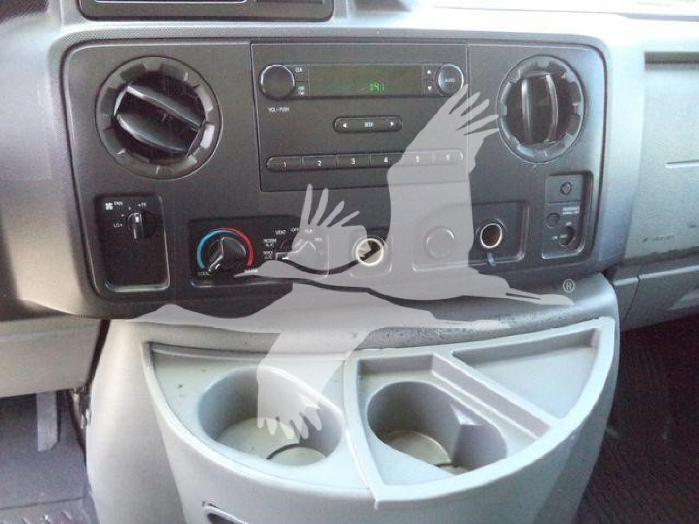 Ford E-450 dashboard view showing center console controls and cup holders.