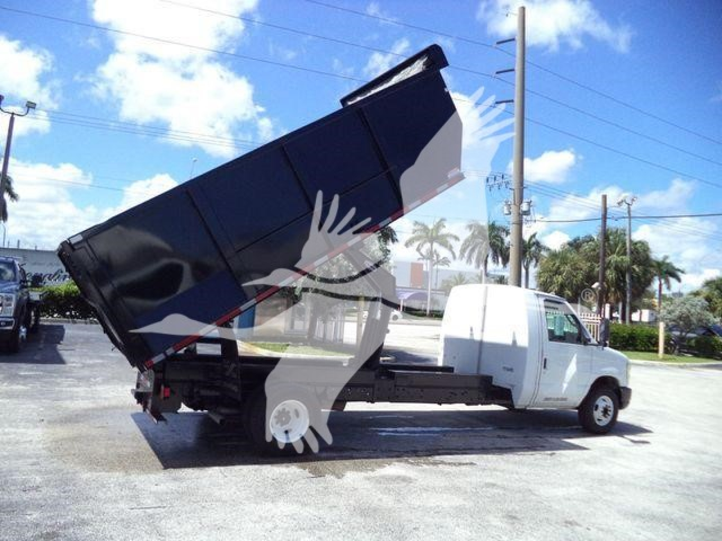 Ford E450 dump truck with elevated bed in-service showing cargo bed and truck cab.