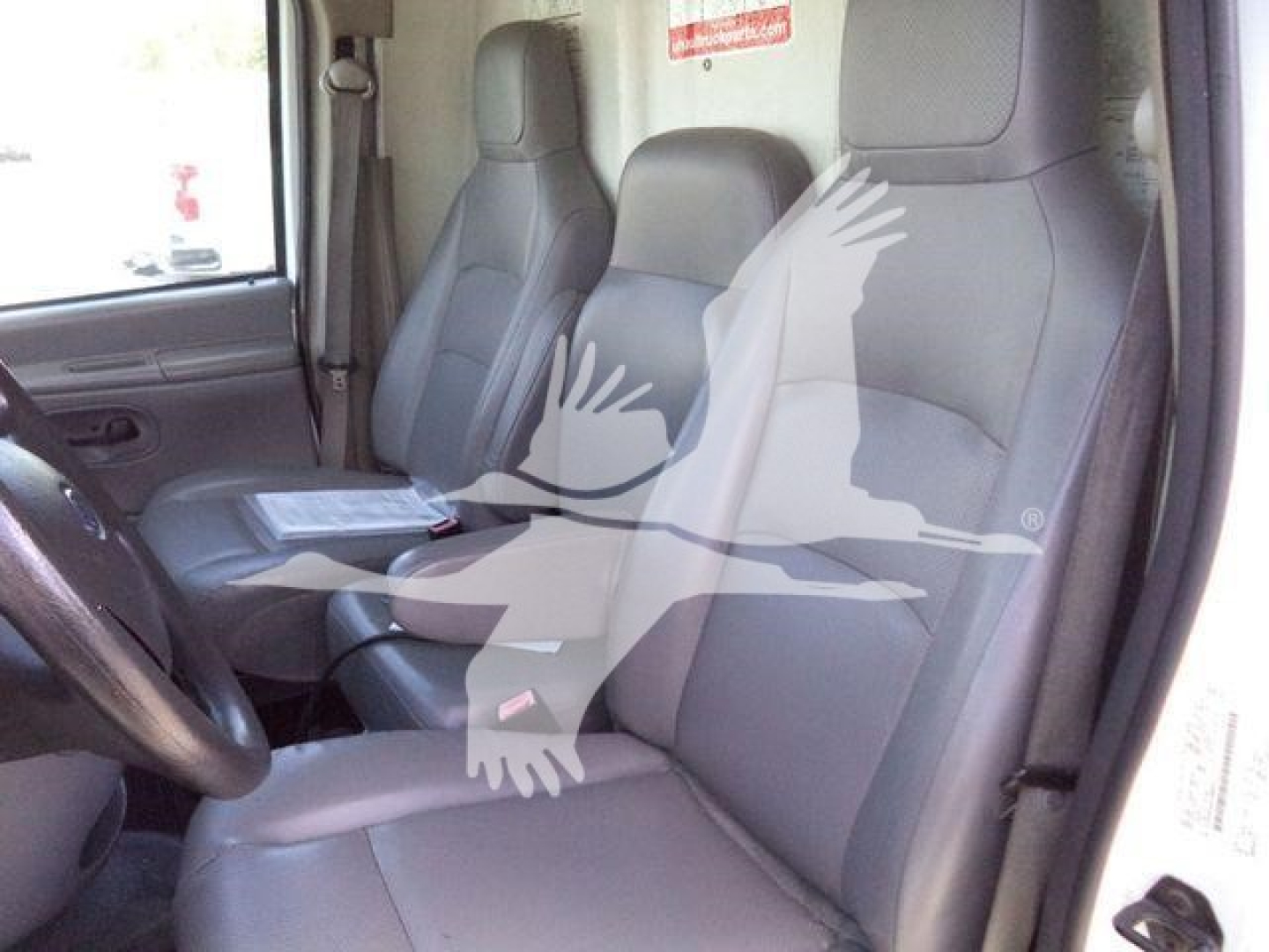 Dashboard and front seats of a Ford E-450 cargo/utility truck interior with gray cloth seats.
