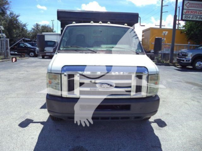 Front view of a white 2011 Ford E450 dump truck showing grille, headlights, and large black front bumper.