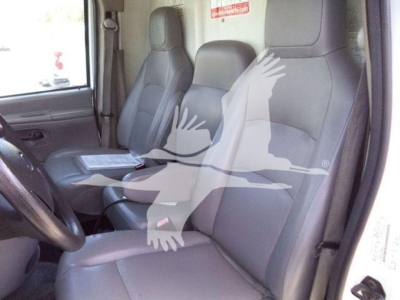 Dashboard and front seats of a Ford E-450 cargo/utility truck interior with gray cloth seats.
