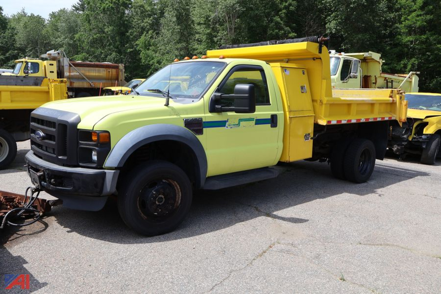 Ford F-450 Super Duty dump truck with yellow dump body and lime green cab, side view, in a lot