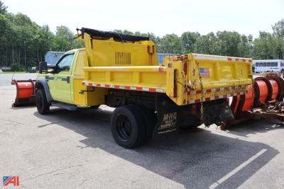 Ford F-450 Super Duty dump truck side/rear view showing yellow dump bed and black chassis with reflection tape