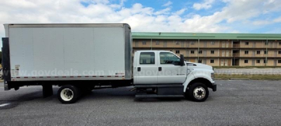 Medium-duty box truck profile shown in side view. White cab and box with no visible branding. Side text watermark from govdeals.com across the image.