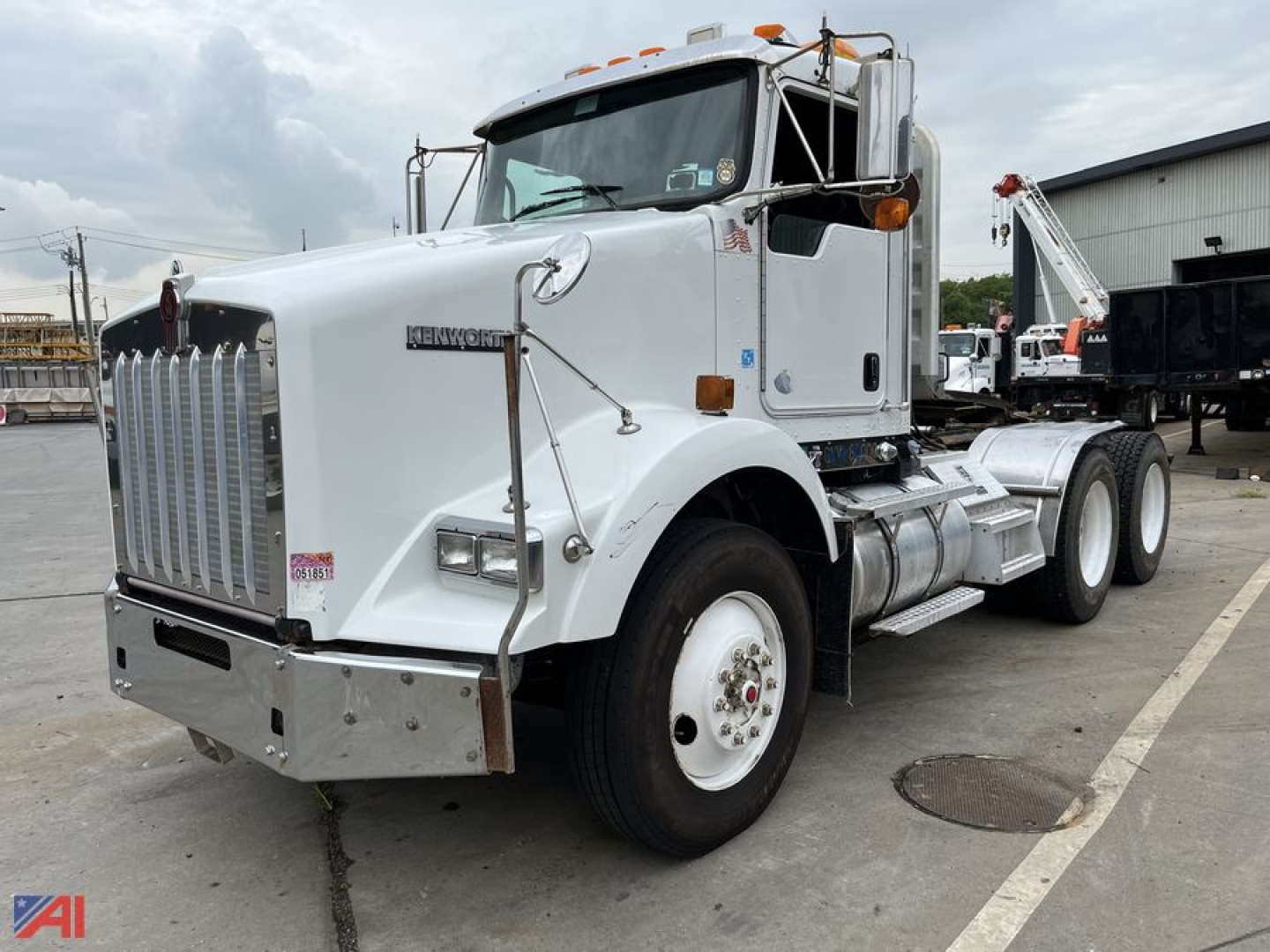 Kenworth T800 tractor in white, front left view, showing chrome grille, dual rear axles, fuel tank, and steps.