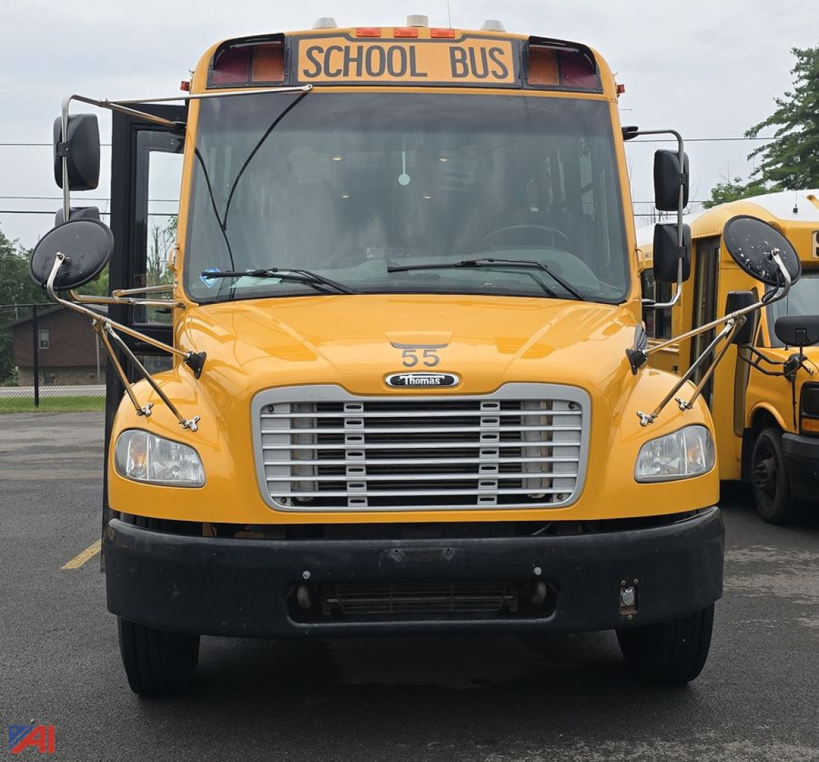 Front view of a yellow 2019 Freightliner Thomas B2 Saf-T-Liner C2 school bus showing school bus sign, large grille, headlights, and mirrors.