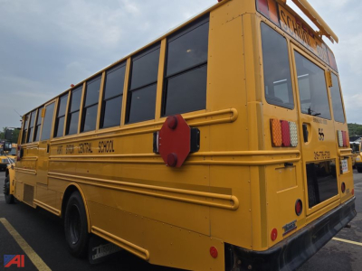 Rear/side view of a yellow Freightliner Saf-T-Liner C2 school bus with black windows and red stop arm. Visible text includes 'SCHOOL', '35', and partial bus markings along the side and rear.