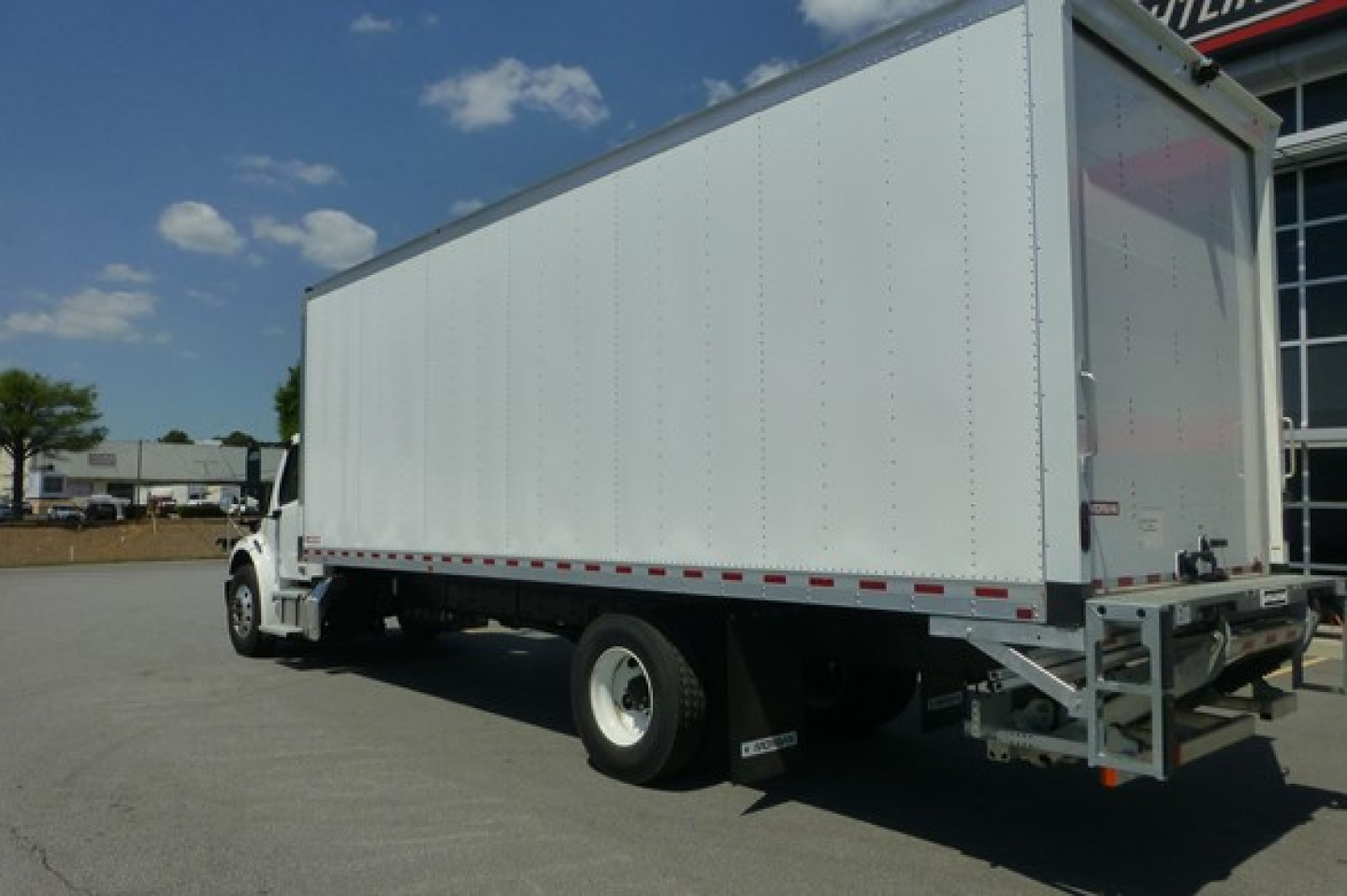 Freightliner M2 106 Plus box truck rear three-quarter view showing dry cargo box and rear doors.