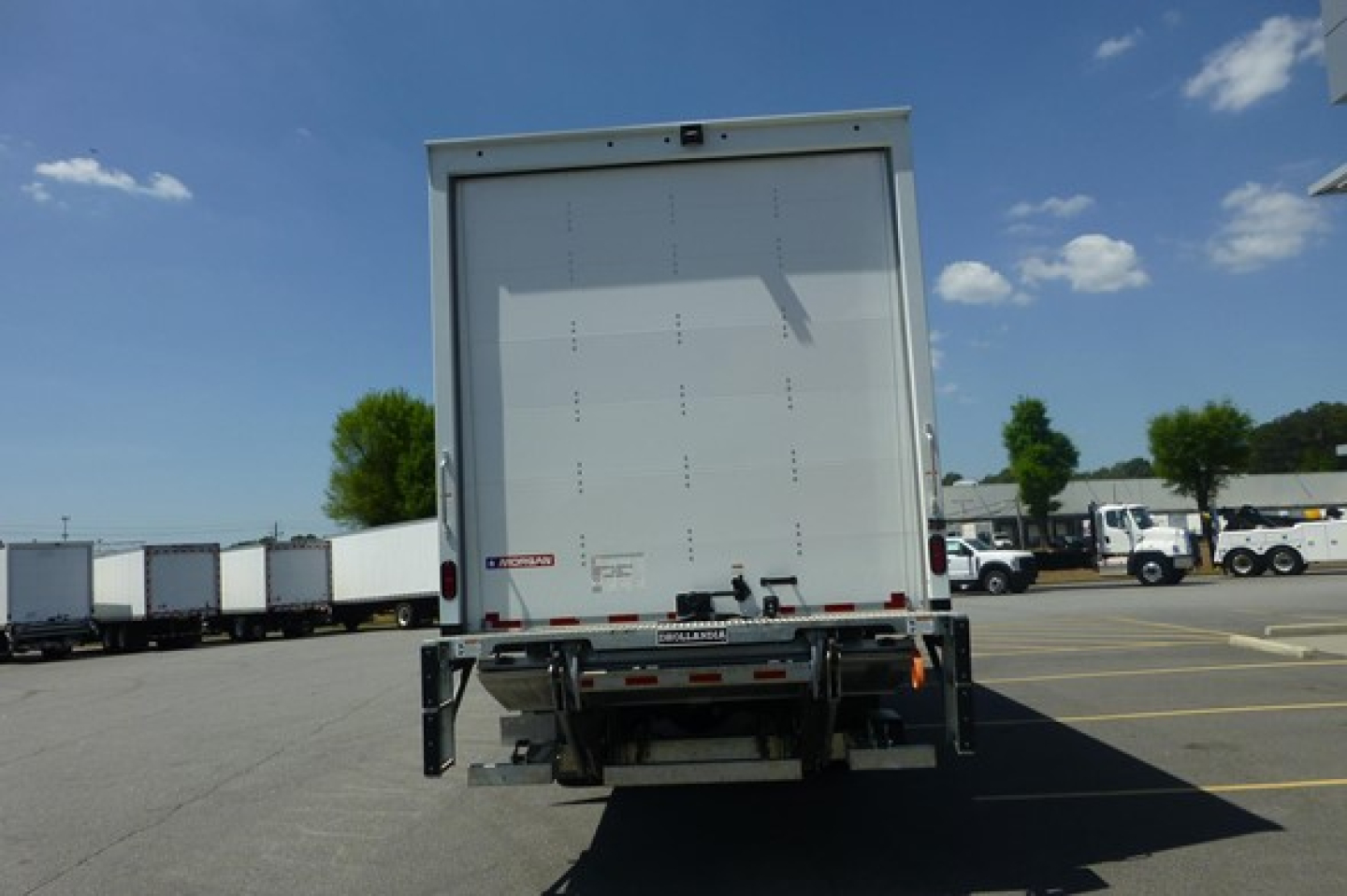 Rear view of a Freightliner M2 106 Plus box truck showing back doors and rear underrun protection.
