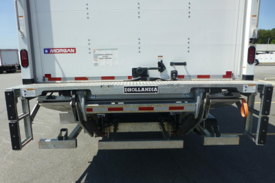 Freightliner M2 106 Plus rear view showing bumper, hitch, and undercarriage with Dhollandia lift system and Morgan sticker.
