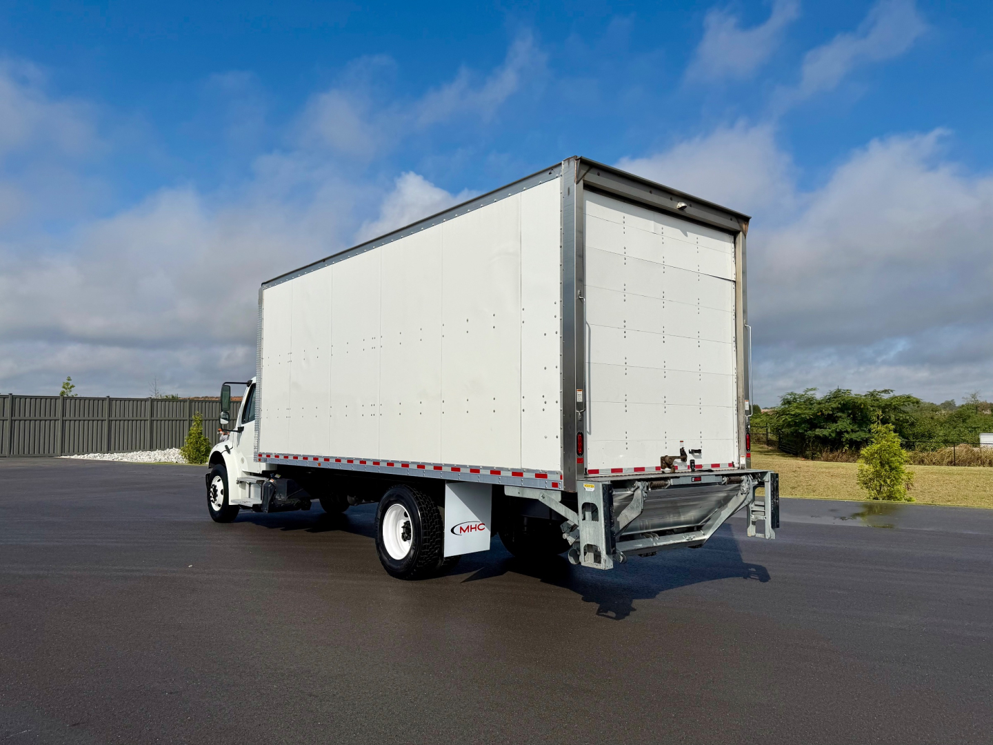 Box truck with rear liftgate showing Cargo area and Freightliner M2-106 style box trailer.
