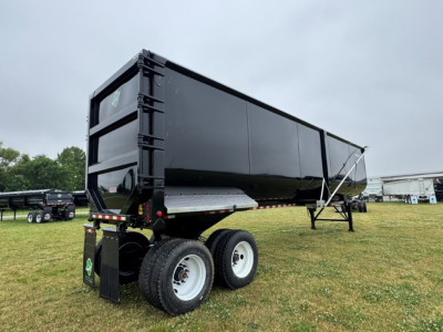 Dump trailer showing side and rear view of a black Armor Lite 40' x 100" scrap trailer with dual rear wheels and stabilizers.