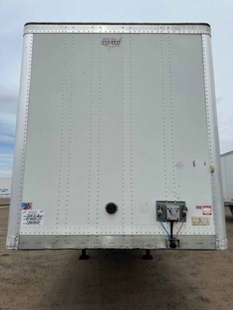 Rear view of a 2014 Wabash van trailer with riveted aluminum exterior, rear door hardware, and inspection stickers visible.