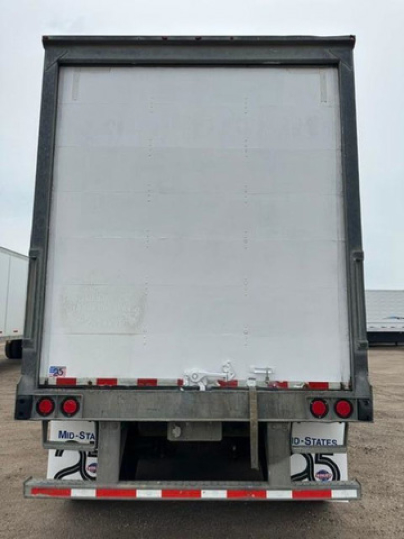 Rear view of a Wabash van trailer showing rear bumper, taillights, and license plate areas with stock number U90818 and US flag decals.