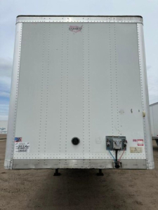 Rear view of a 2014 Wabash van trailer with riveted aluminum exterior, rear door hardware, and inspection stickers visible.