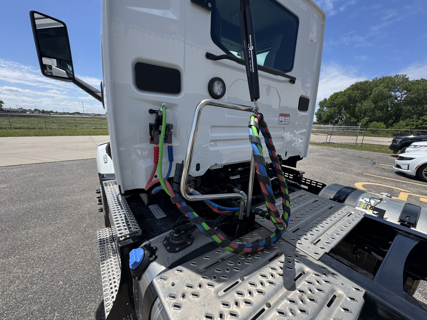 Mack AN64T cab rear view showing colorful braided electrical harnesses and metal step deck