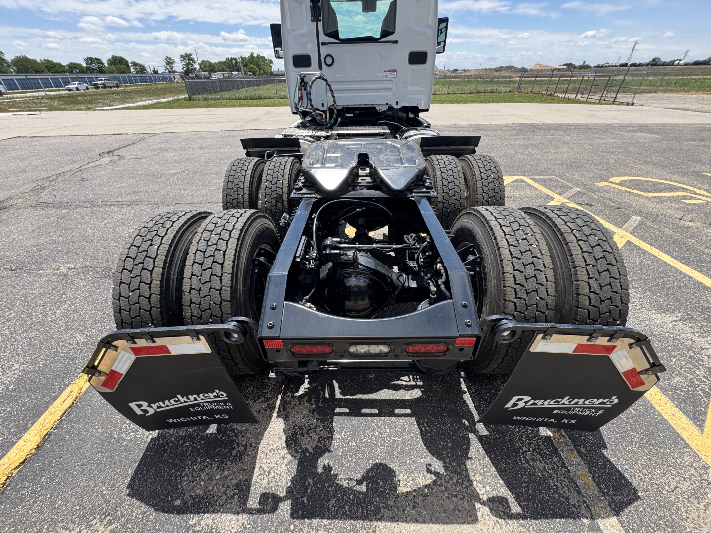 Mack AN64T conventional daycab rear view showing chassis, dual rear axles, fifth-wheel area, and mud flaps with Brandt truck branding
