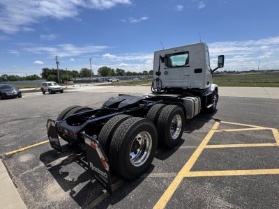Mack AN64T conventional daycab tractor rear/side view showing fifth wheel and dual rear axles with tires and white cab.