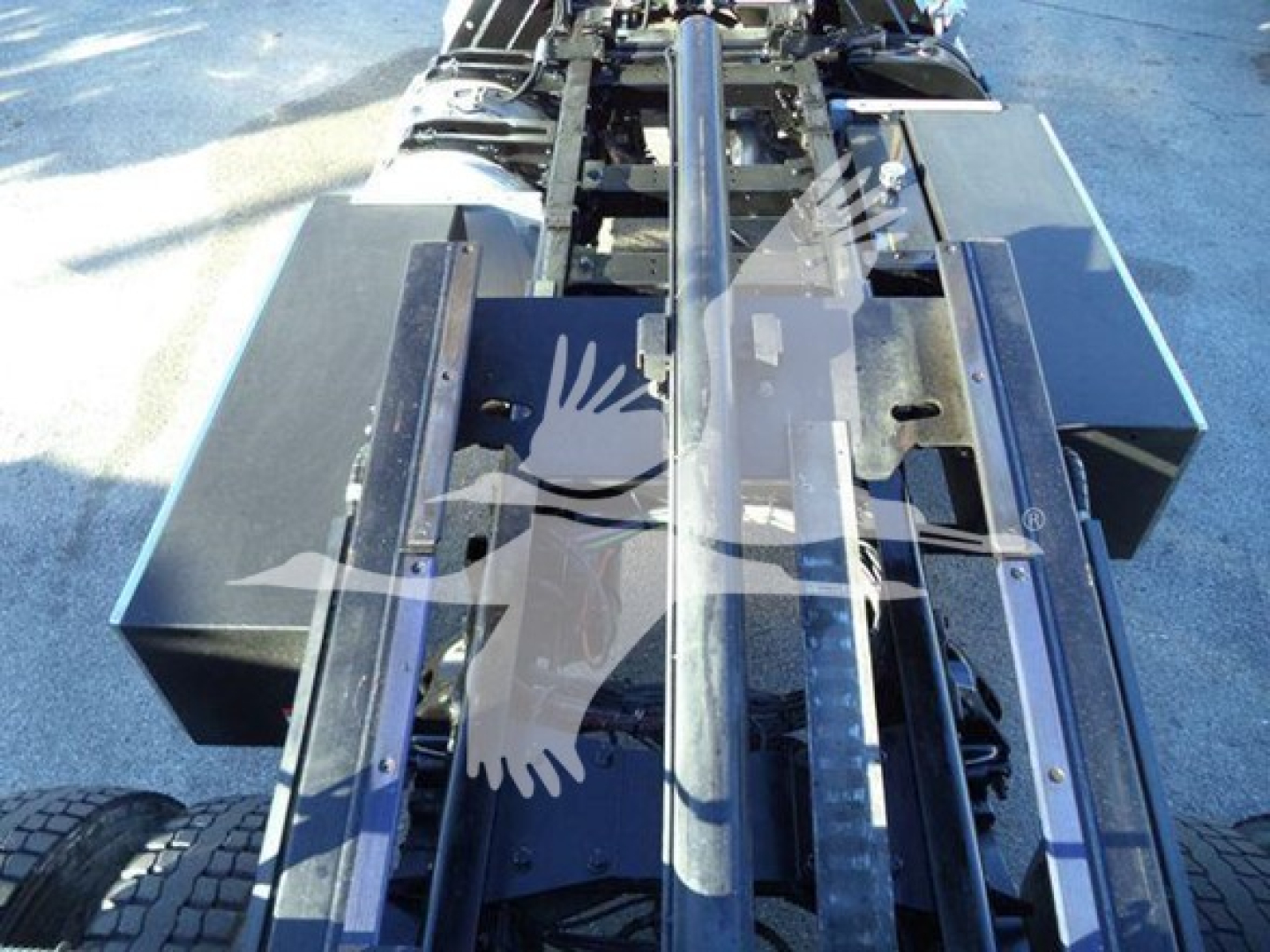 Tractor truck chassis of a 2020 Peterbilt 337 rollback showing metal hitch frame and hydraulic components.