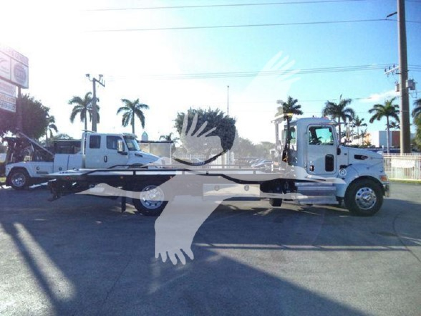 Peterbilt 337 rollback truck shown in side profile with a long flatbed attachment.