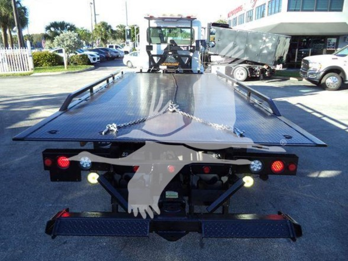 Peterbilt 337 rollback bed platform rear view showing metal flatbed with chains and taillights.