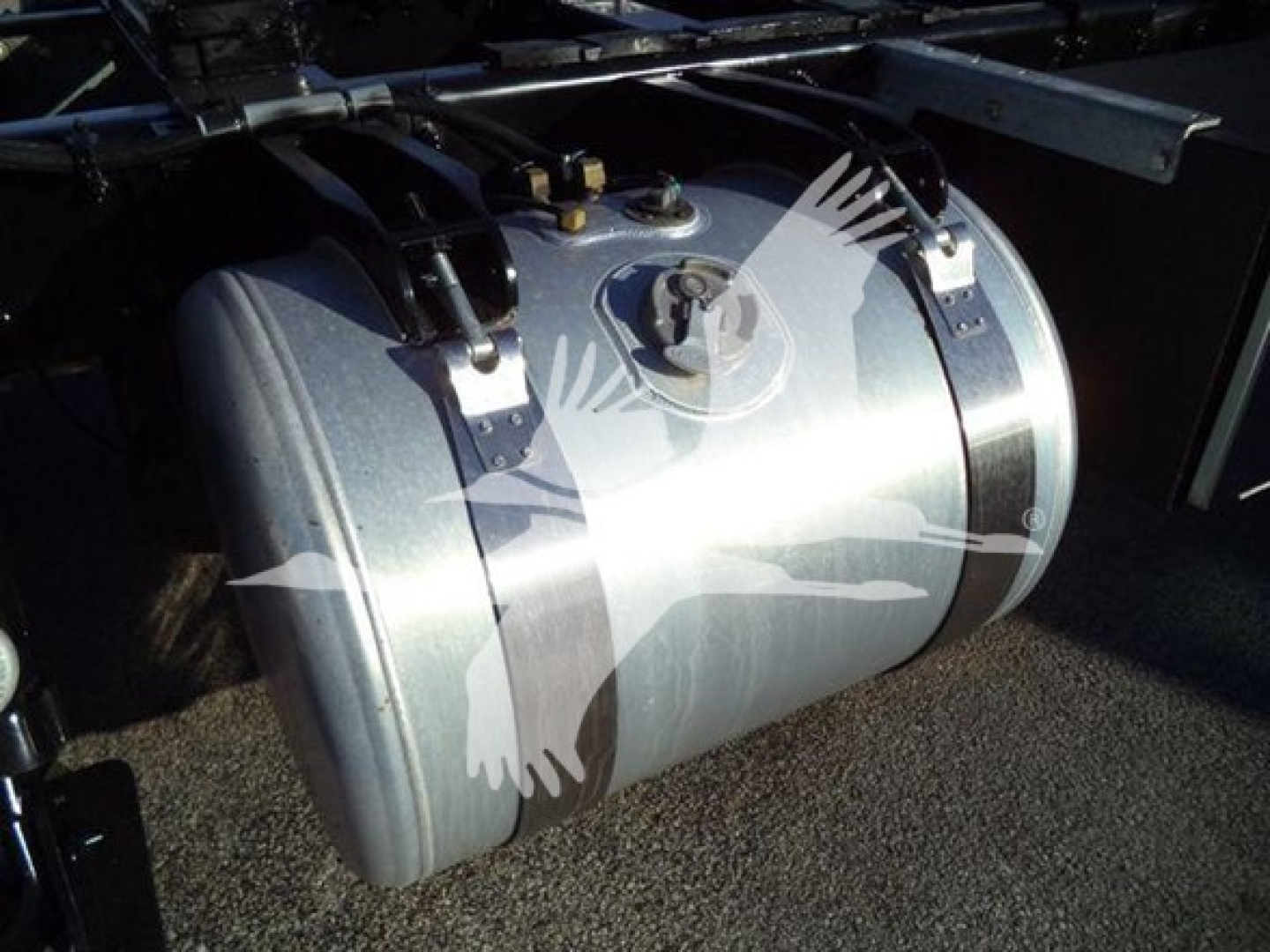 Peterbilt 337 rollback showing large cylindrical fuel tank mounted under the frame.