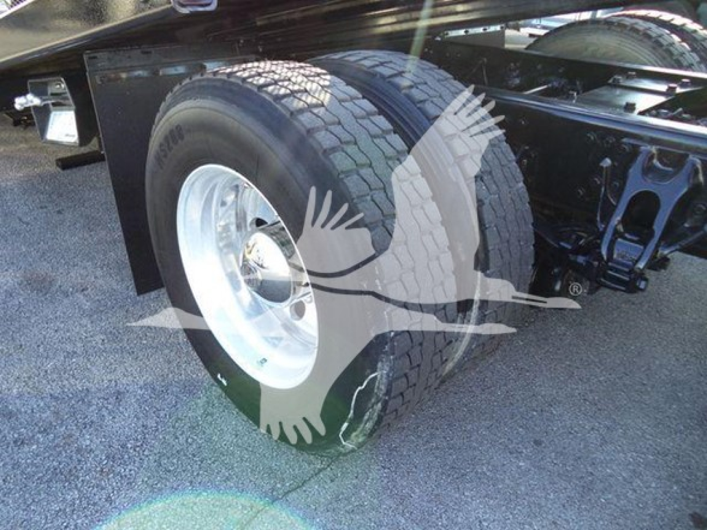 Peterbilt 337 rollback truck rear wheel and suspension visible, dual rear tires and chassis.