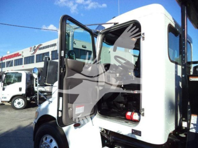 Peterbilt 337 rollback truck cab with open door showing interior and dashboard.