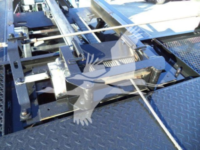 Peterbilt 337 rollback truck chassis showing tow cable winch and frame components.
