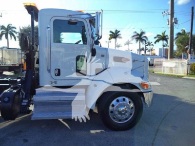 Peterbilt 337 rollback truck side view showing cab, front wheel, and crane attachment area.