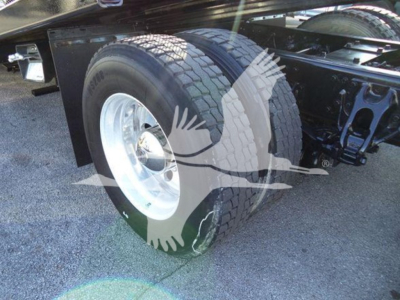 Peterbilt 337 rollback truck rear wheel and suspension visible, dual rear tires and chassis.