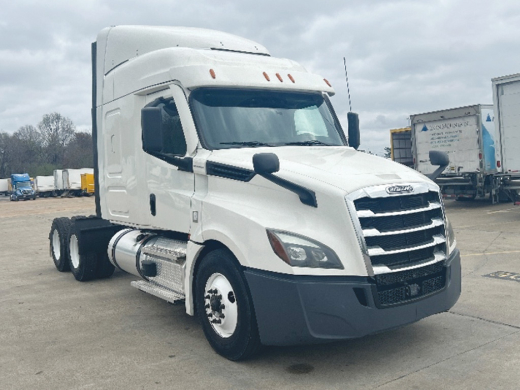 2020 Freightliner Cascadia126 truck in a parking lot, front-left view showing Freightliner grille, side mirrors, cab with sleeper, and fuel tanks.