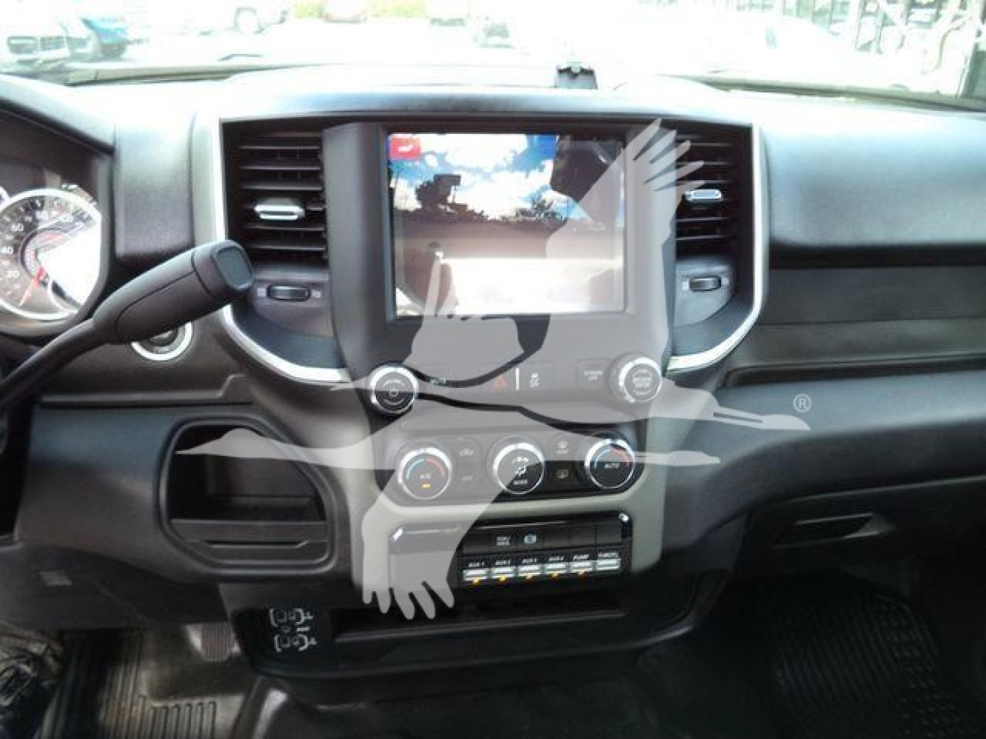Dashboard of a Ram 5500 SLT showing center touchscreen display, climate control knobs, and driver-side steering column.