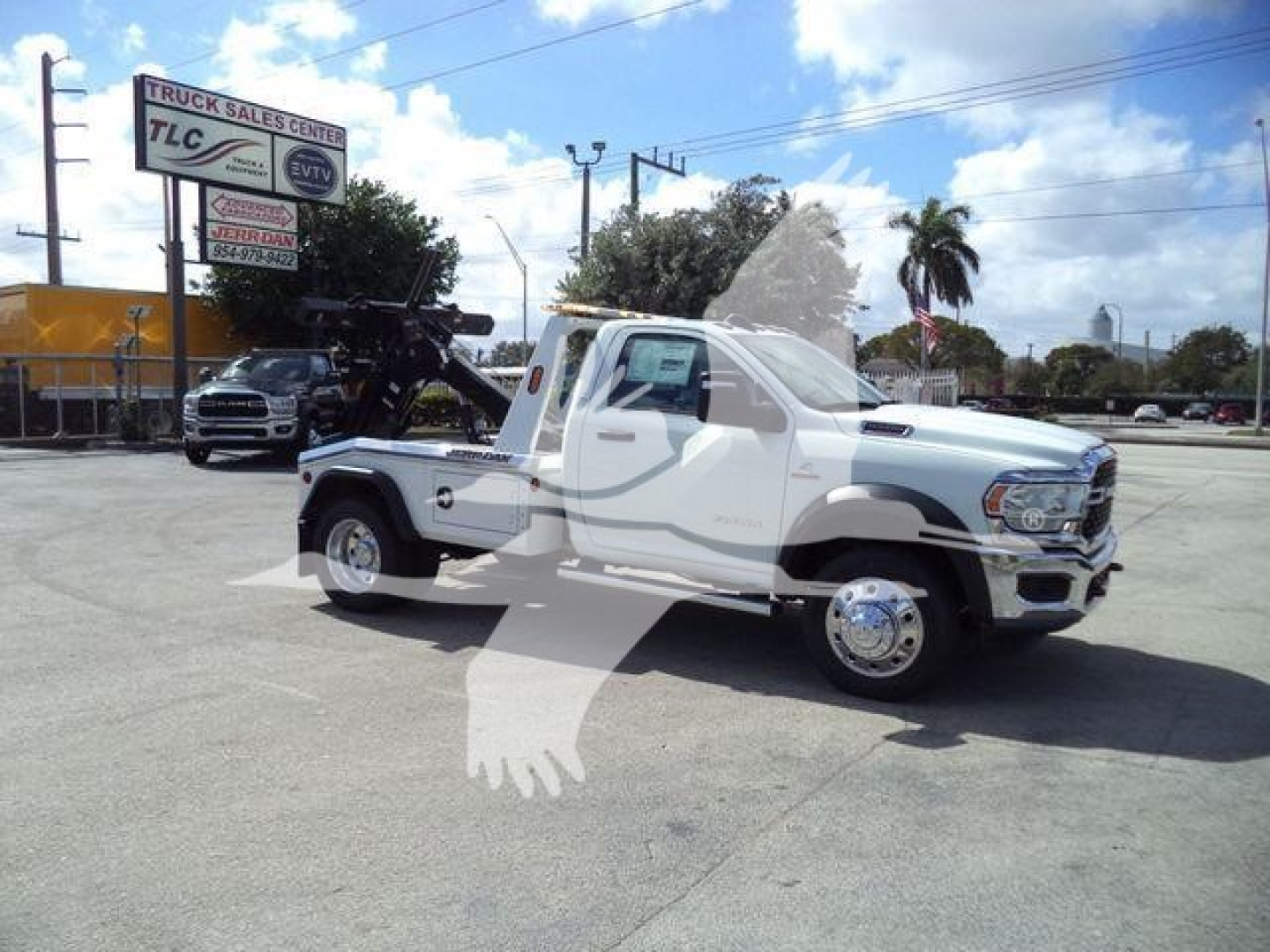 Truck showing a white 2024 Ram 5500 SLT with a tow winch in a dealership lot; stock number J40087FM; category Winch; new vehicle; trucks type.