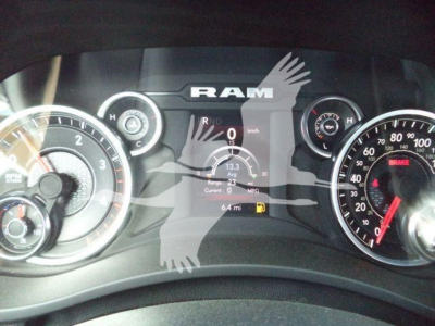Ram 5500 dashboard cluster showing speedometer and tachometer with RAM logo overlay. Instrument panel displays digital readouts and gauges.