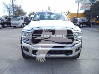 Truck front view showing 2024 Ram 5500 SLT badge, large chrome grille, RAM emblem, and bumper with fog lights.
