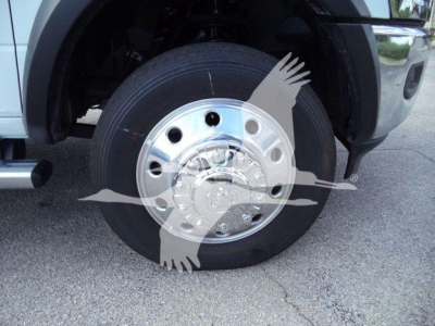 Truck wheel on Ram 5500 SLT showing polished hubcap and tire tread with fender and side step visible