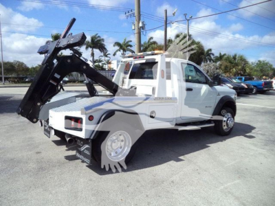 Ram 5500 tow truck with large crane/winch assembly in rear, white cab and flatbed, stock number J40087FM, category winch, new vehicle.