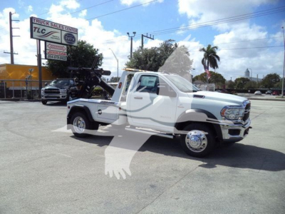 Truck showing a white 2024 Ram 5500 SLT with a tow winch in a dealership lot; stock number J40087FM; category Winch; new vehicle; trucks type.