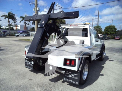 Ram 5500 tow truck with heavy-duty winch system mounted over bed, rear view showing tow apparatus and bumper lights.