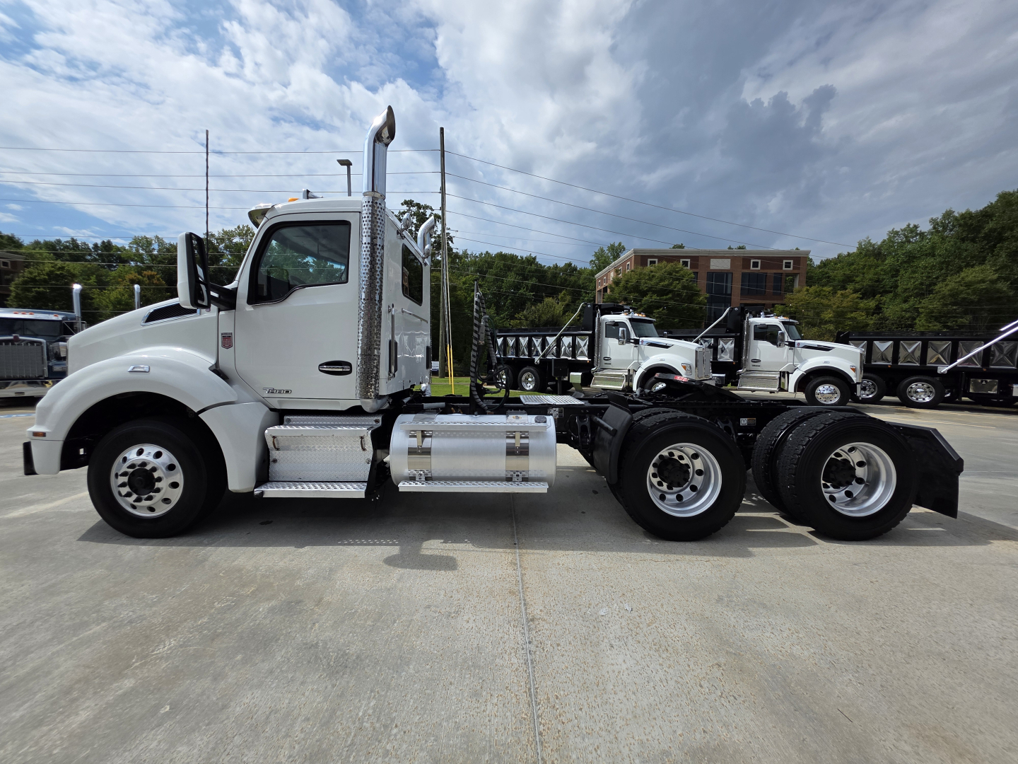 Side view of a white 2020 Kenworth T880 conventional daycab tractor. Visible text includes Kenworth emblem on door, exhaust stack, fuel tanks, and chassis. No visible damage details.