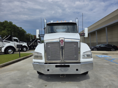 Kenworth T880 conventional daycab front view showing large chrome grille and bumper.