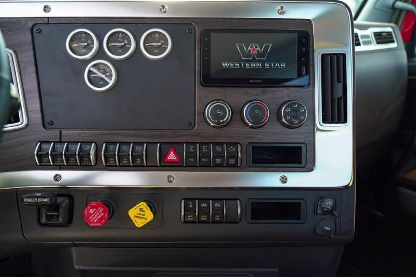 Western Star 49X dashboard showing gauges, center infotainment screen, control switches, and hazard button panel