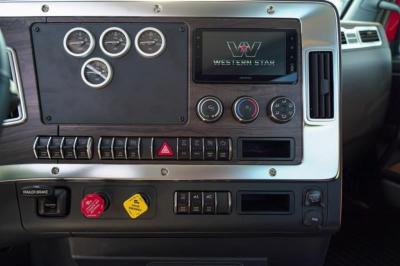 Western Star 49X dashboard showing gauges, center infotainment screen, control switches, and hazard button panel