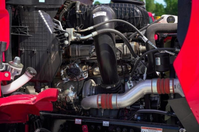 Western Star 49X engine bay showing turbocharger, intake pipe, hoses, radiator, and surrounding components.