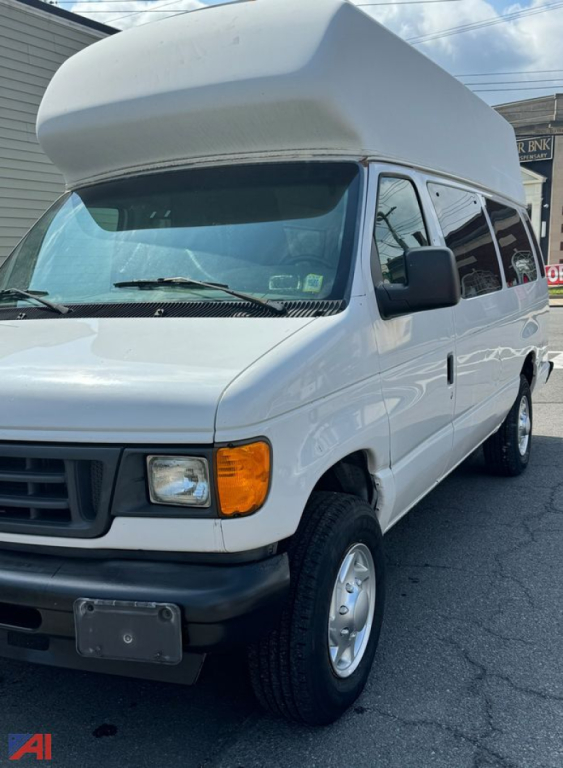 Full-size white Ford EC3 passenger van with raised roof showing front and side view including orange front marker light, black front bumper, and blank rear window.