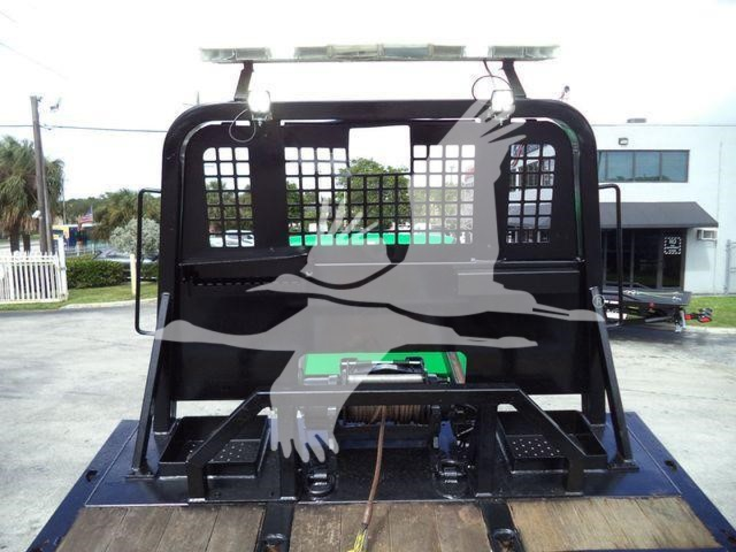 Truck bed setup with a protective cage and hydraulic components; no readable model details other than general truck bay.