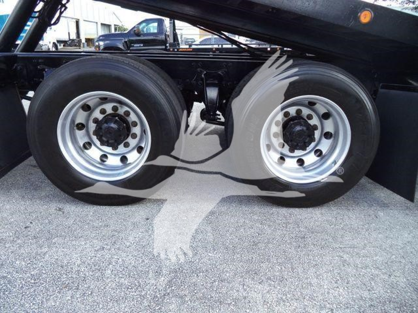 Freightliner M2 106 rollback chassis showing dual rear wheels and wheel hubs.