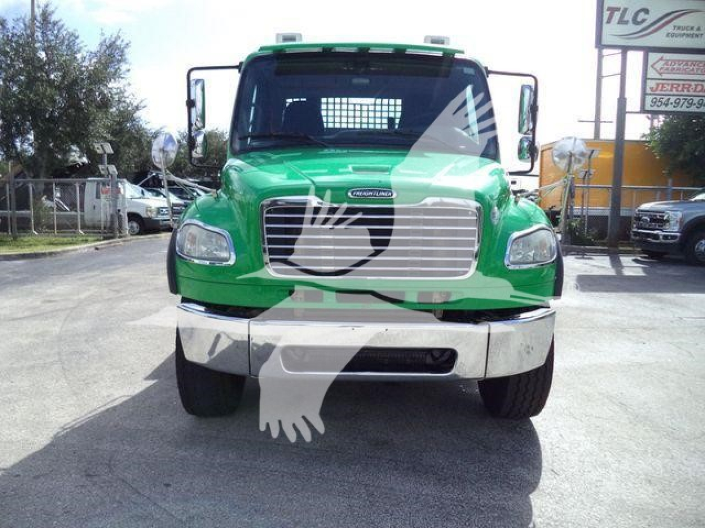 Green 2015 Freightliner M2 106 front view with chrome grille, headlights, and bumper. Stock TD9494FM visible. Truck is a rollback category, used.